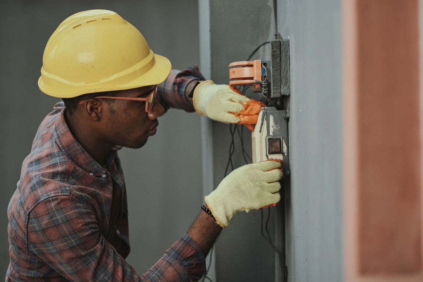 Licensed electrician working in a residential service panel in Denver